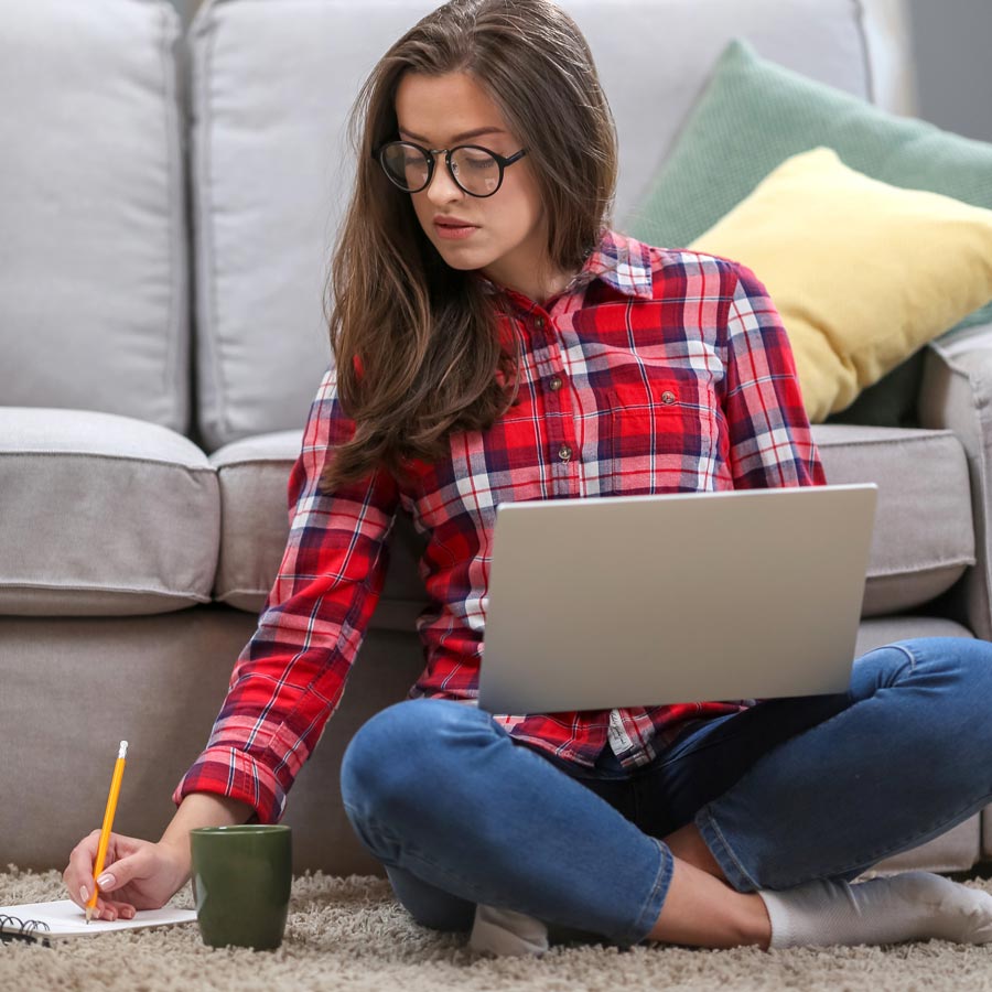 Occupational therapist pushes client in wheelchair on playground